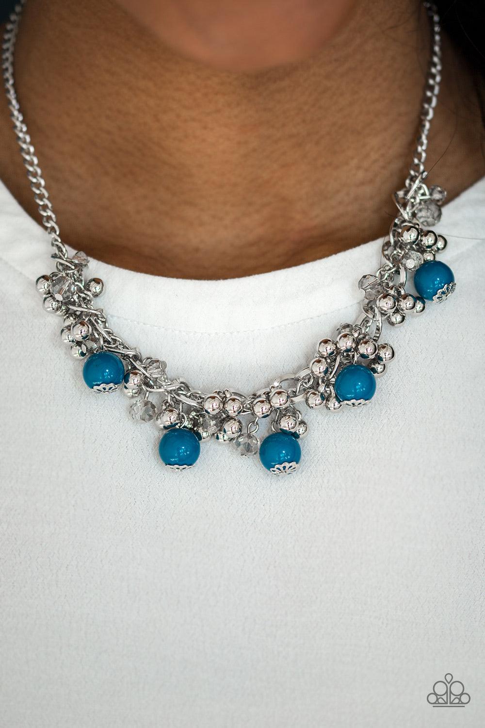 Paparazzi Accessories A Pop of Posh - Blue Crystal like beads and classic silver beads dangle from a bold silver chain, creating a clustered fringe below the collar. Polished blue beads trickle between the clustered beading, adding a casual pop of color t