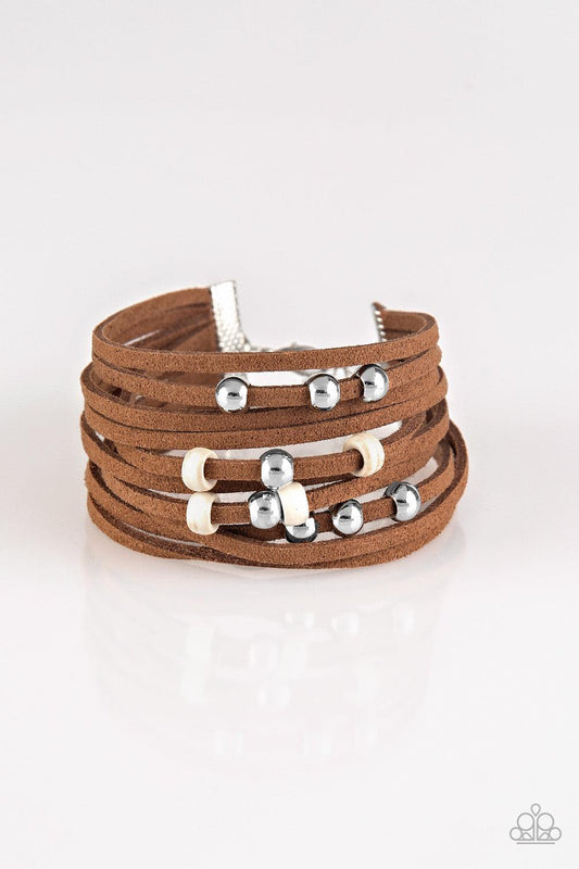 Paparazzi Accessories Colorfully Coachella - White Dainty white wooden beads and classic silver beads are threaded along strands of brown suede, creating colorful layers across the wrist. Features an adjustable clasp closure. Sold as one individual bracel