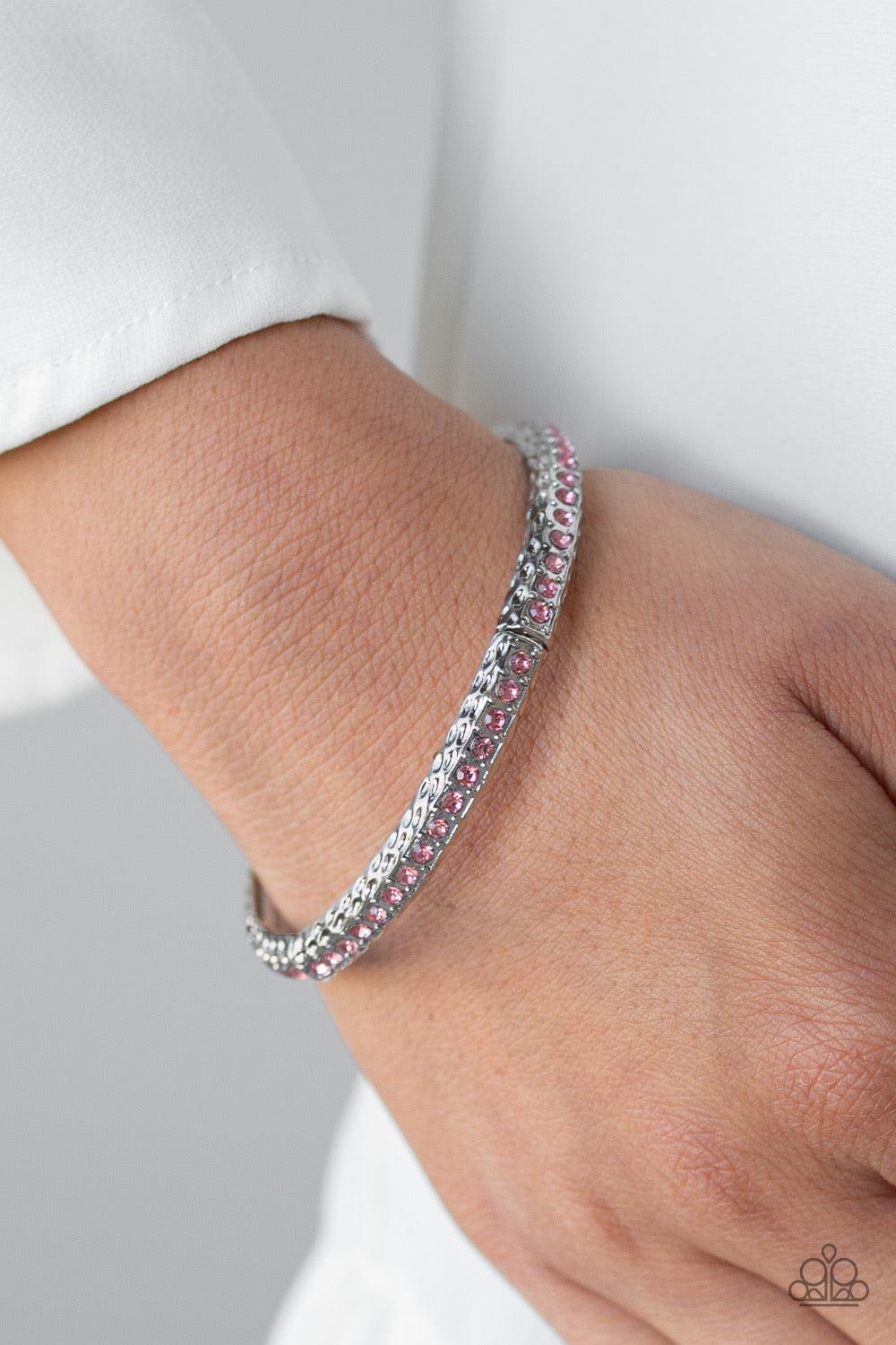 Paparazzi Accessories Cha Cha Ching! - Purple Encrusted in a row of glittery pink rhinestones, hammered silver frames are threaded along a stretchy band around the wrist for a glamorous bangle-like look. Jewelry