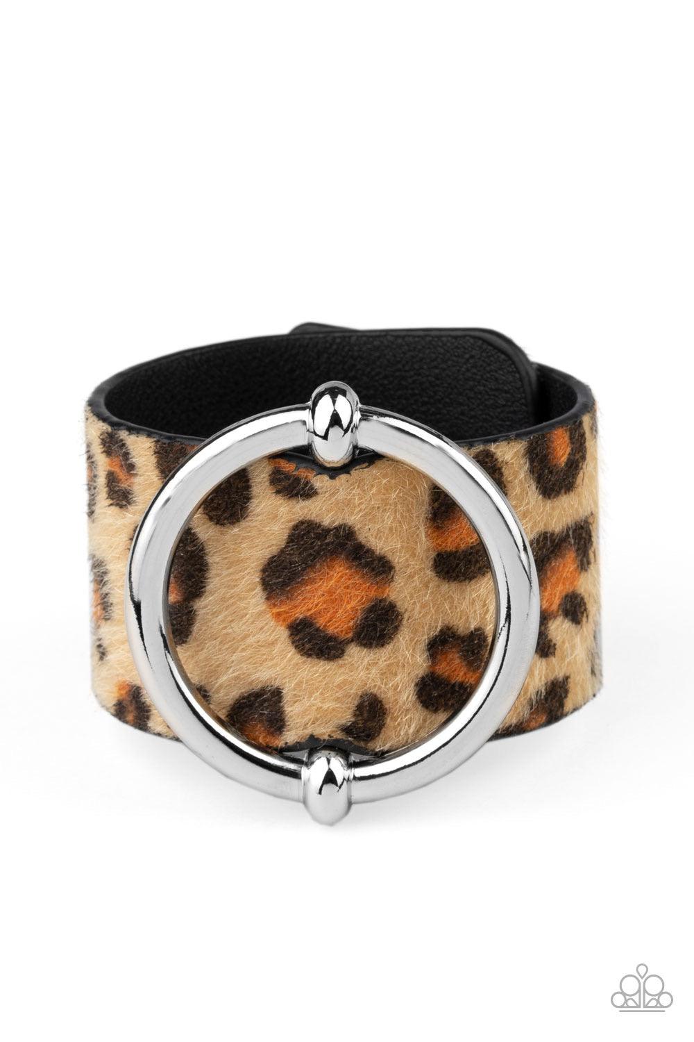 Paparazzi Accessories Asking FUR Trouble - Brown A dramatically oversized silver ring slides along a thick black leather band featuring fuzzy brown cheetah print for a wild finish. Features an adjustable snap closure. Sold as one individual bracelet. Jewe