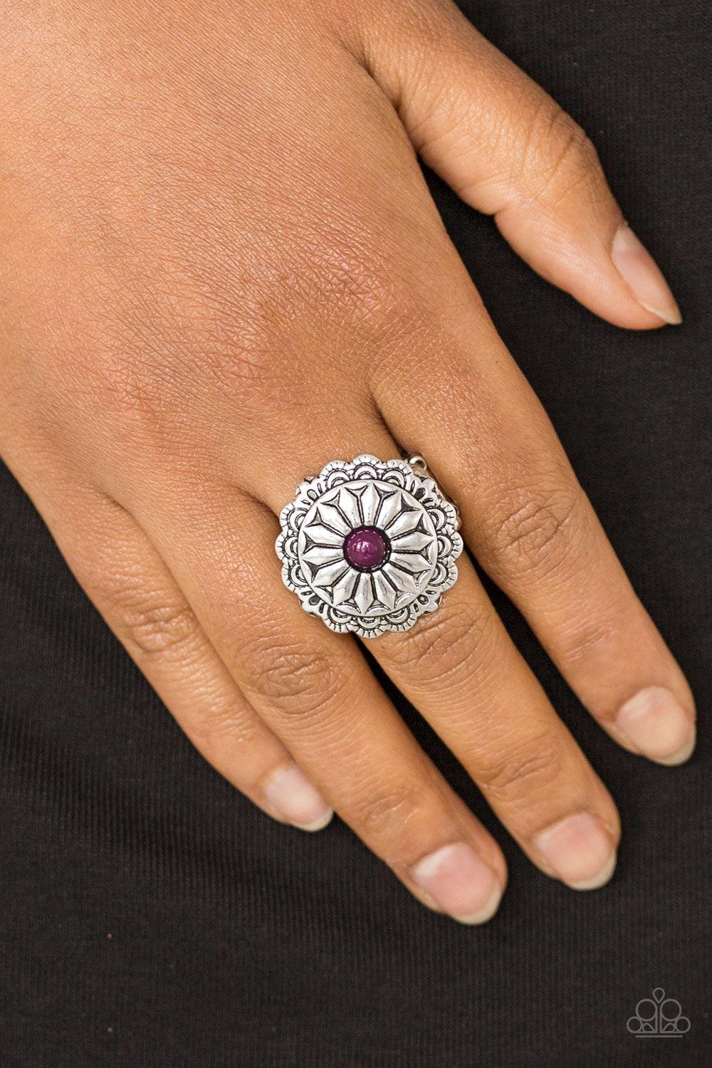 Paparazzi Accessories Daringly Daisy - Purple A shiny purple bead is pressed into a glistening silver frame radiating into a floral detail for a seasonal look. Features a stretchy band for a flexible fit. Jewelry