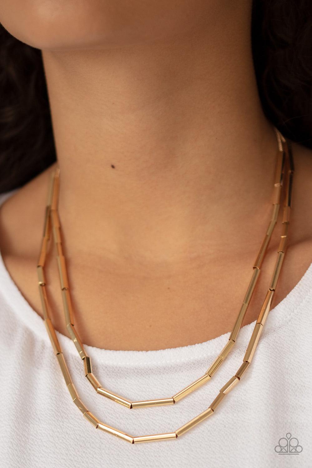 Paparazzi Accessories A Pipe Dream - Gold A collection of square rods slide along two dainty gold chains below the collar, creating edgy metallic layers. Features an adjustable clasp closure. Jewelry