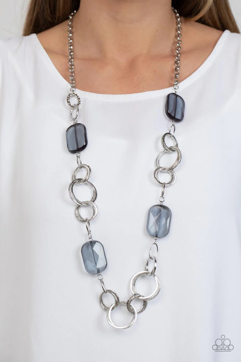 Paparazzi Accessories Stained Glass Glamour - Silver Featuring a faceted shimmer, oversized smoky beads give way to sections of delicately hammered silver hoops across the chest for a colorful flair. Features an adjustable clasp closure.