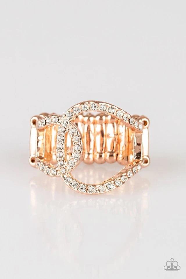 Paparazzi Accessories Radical Radiance - Rose Gold Encrusted in glassy white rhinestones, two rose gold links join into an asymmetrical band across the finger for a refined look. Features a stretchy band for a flexible fit. Interconnecting rhinestone circ