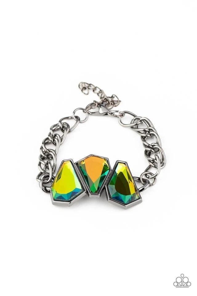 Paparazzi Accessories Raw Radiance - Multi Attached to a shiny gunmetal chain, a trio of sparkly oil spill gem-shaped rhinestones join into a glamorous centerpiece atop the wrist. Features an adjustable clasp closure. Sold as one individual bracelet. Jewe