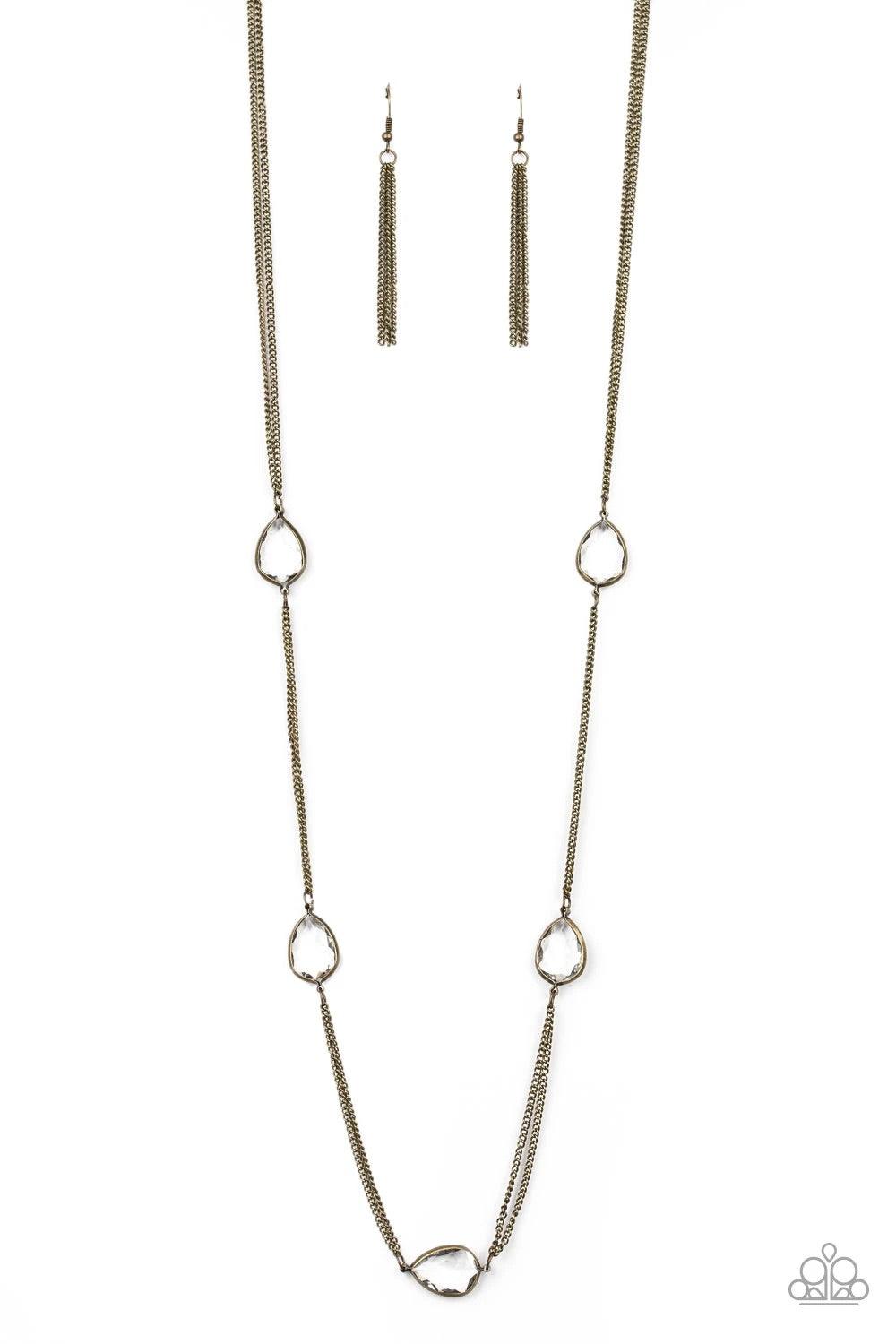 Paparazzi Accessories Teardrop Timelessness - Brass Glassy white teardrops attach to sections of antiqued brass chain across the chest, creating a refined display. Features an adjustable clasp closure. Jewelry