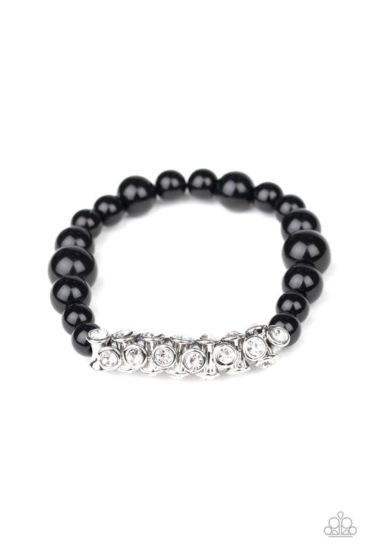 Paparazzi Accessories Traffic Stopping Sparkle - Black A collection of black beads and white rhinestone dotted silver frames are threaded along a stretchy band around the wrist, creating a sparkling centerpiece. Sold as one individual bracelet. Jewelry