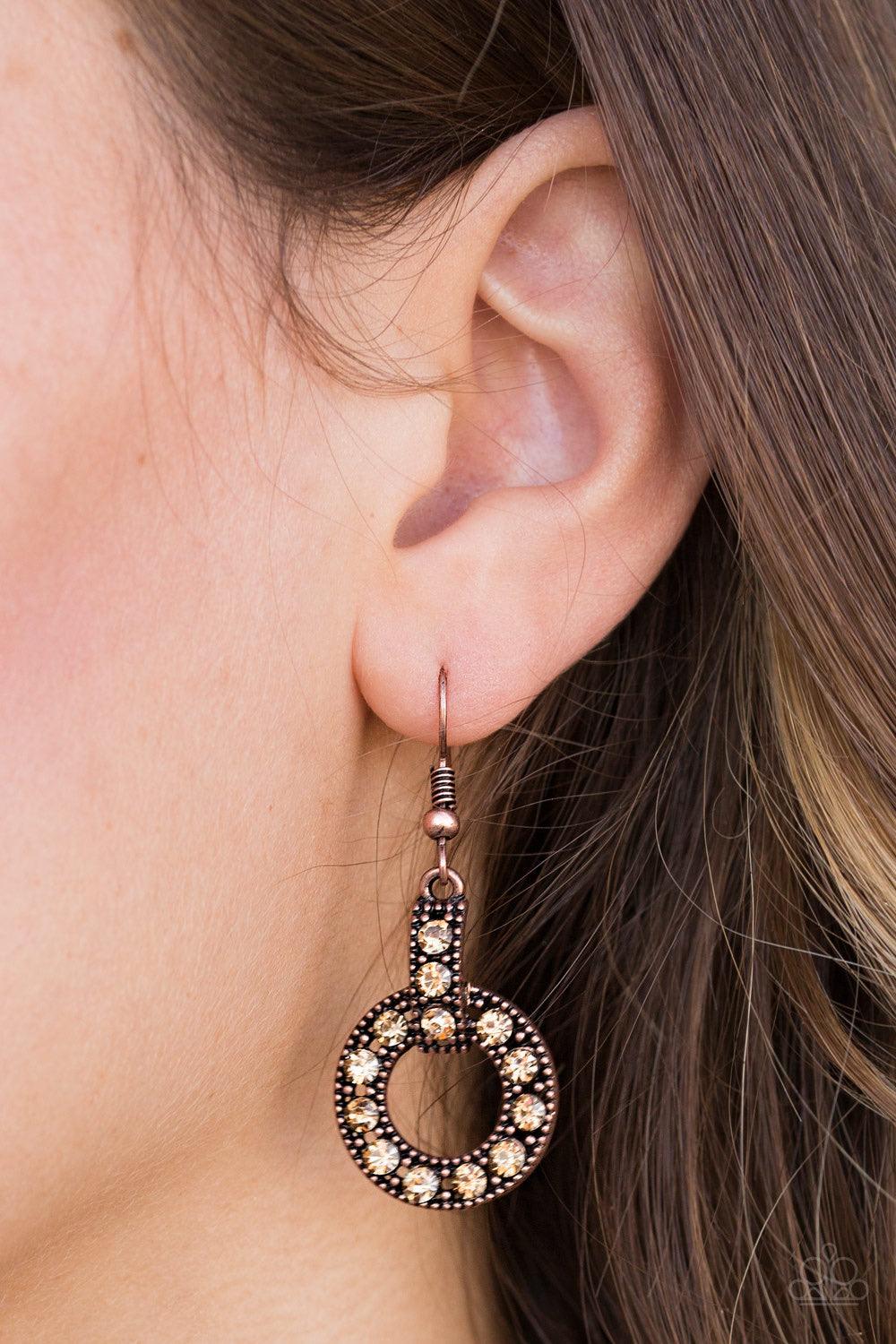 Paparazzi Accessories Midnight Ball - Copper Golden topaz rhinestones are encrusted along a shimmery copper hoop and frame, creating an elegant lure. Earring attaches to a standard fishhook fitting. Jewelry