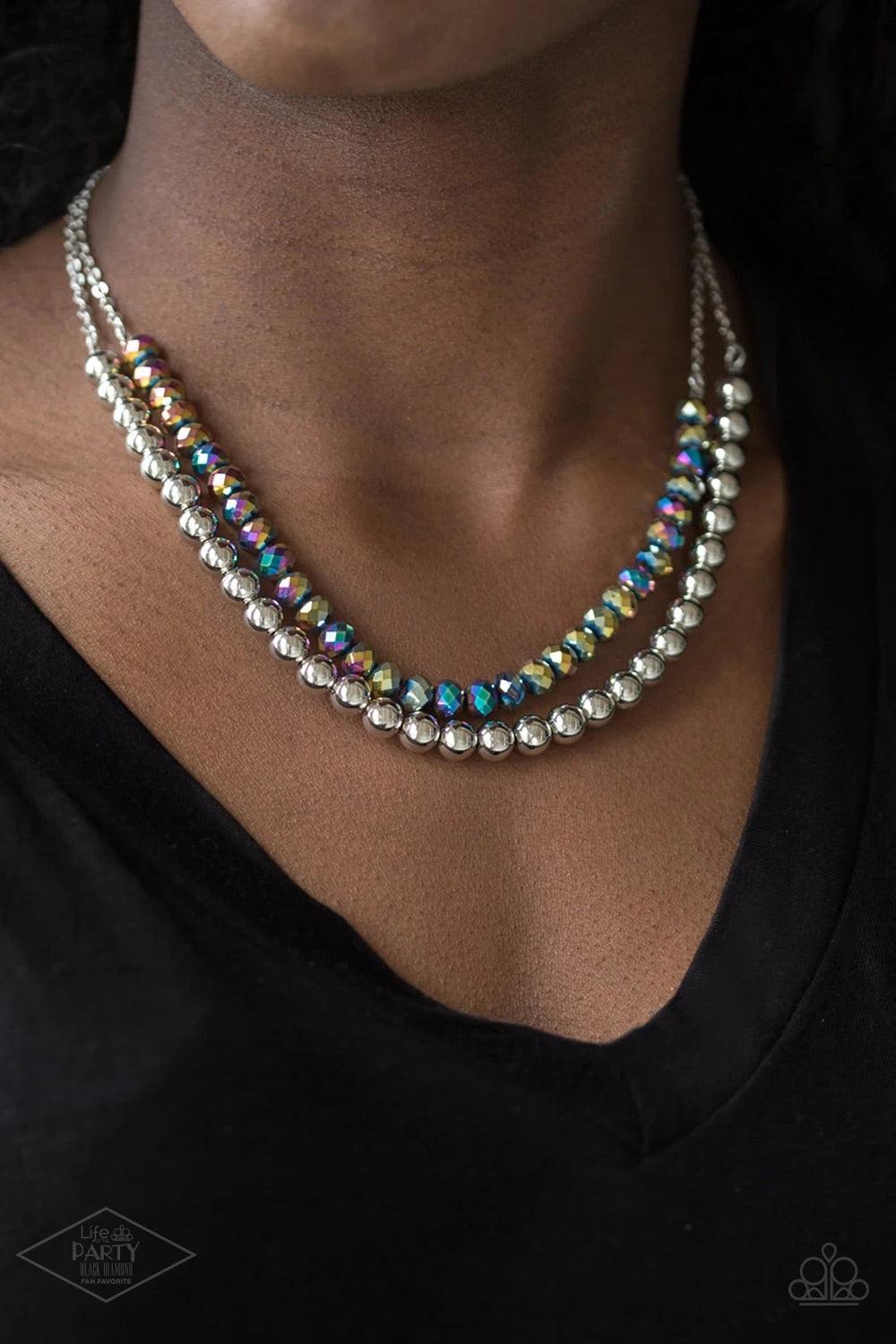 Paparazzi Accessories Color of the Day - Multi Dipped in a rainbow iridescence, a strand of metallic crystal-like beads gives way to a strand of shiny silver beads below the collar for a colorfully layered look. Features an adjustable clasp closure. Sold