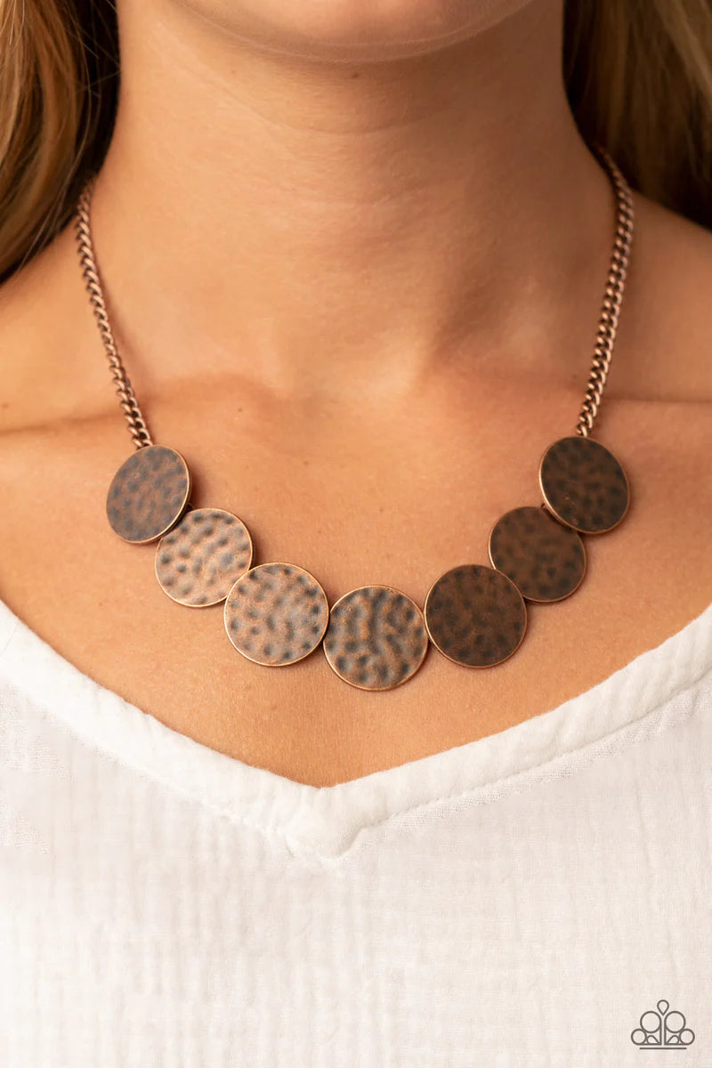 Paparazzi Accessories Flip A Coin - Copper Brushed in a rustic finish, a row of hammered copper discs delicately overlap as they link below the collar for a gritty edge. Features an adjustable clasp closure. Sold as one individual necklace. Includes one p