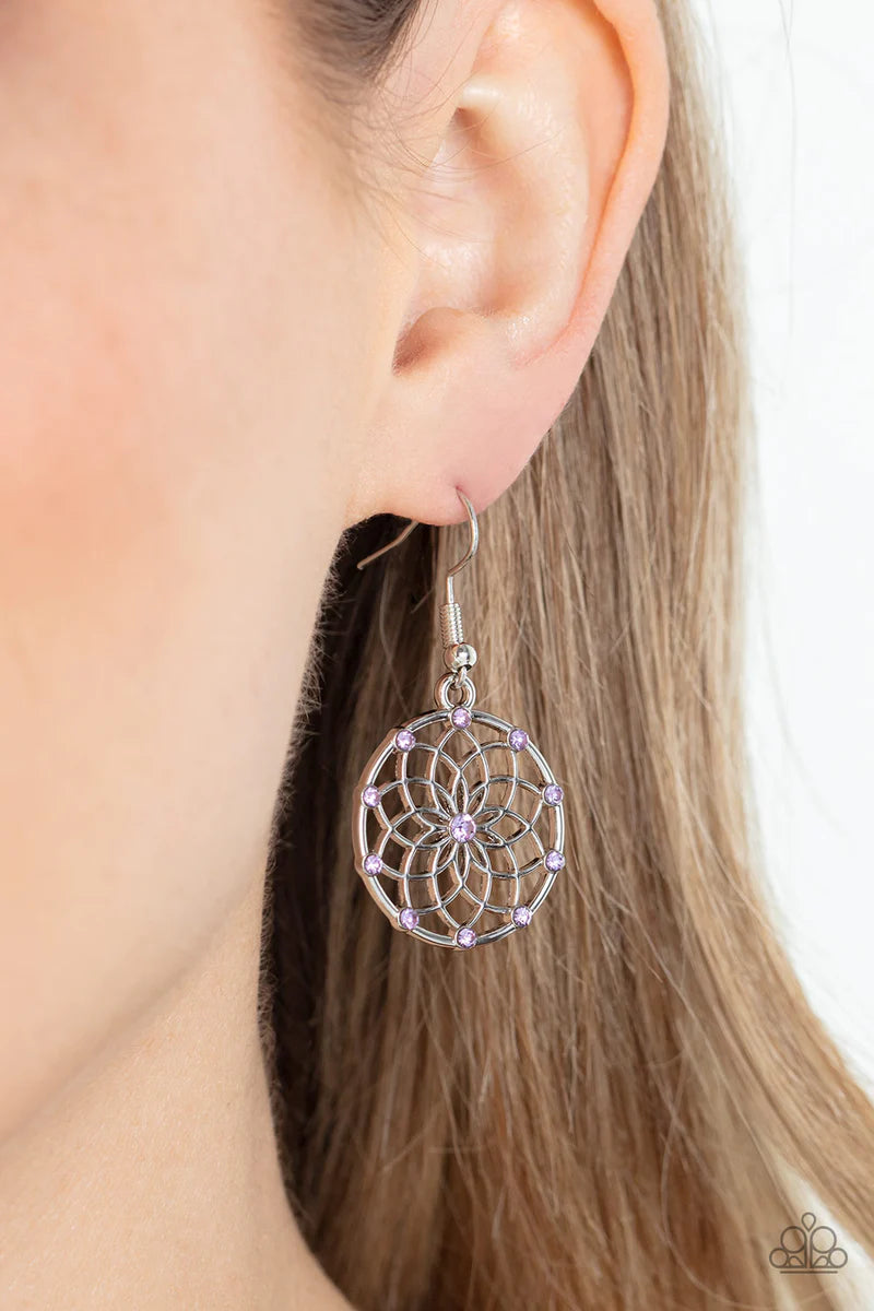 Paparazzi Accessories Springtime Salutations - Purple Dotted with dainty purple rhinestones, an airy mandala-like blossom blooms inside a silver hoop for a seasonal shimmer. Earring attaches to a standard fishhook fitting. Sold as one pair of earrings. Je