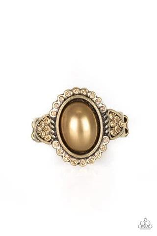 Paparazzi Accessories Pearl Party - Brass A pearly brass bead is pressed into the center of an ornate brass frame radiating with golden topaz rhinestones for a refined look. Features a stretchy band for a flexible fit. Sold as one individual r Jewelry