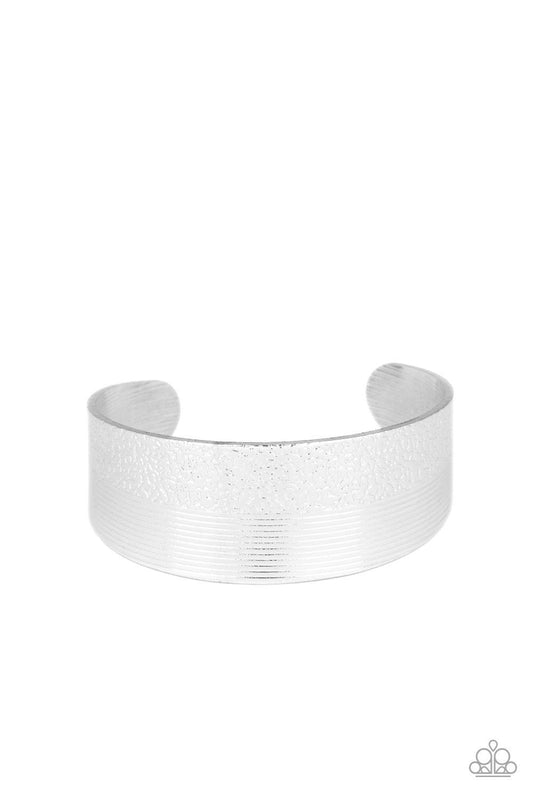 Paparazzi Accessories Mixed Vibes - Silver One half of a thick silver cuff is engraved in stacked linear lines while the other half is hammered in a row of tactile textures, creating a collision of texture around the wrist. Sold as one individual bracelet