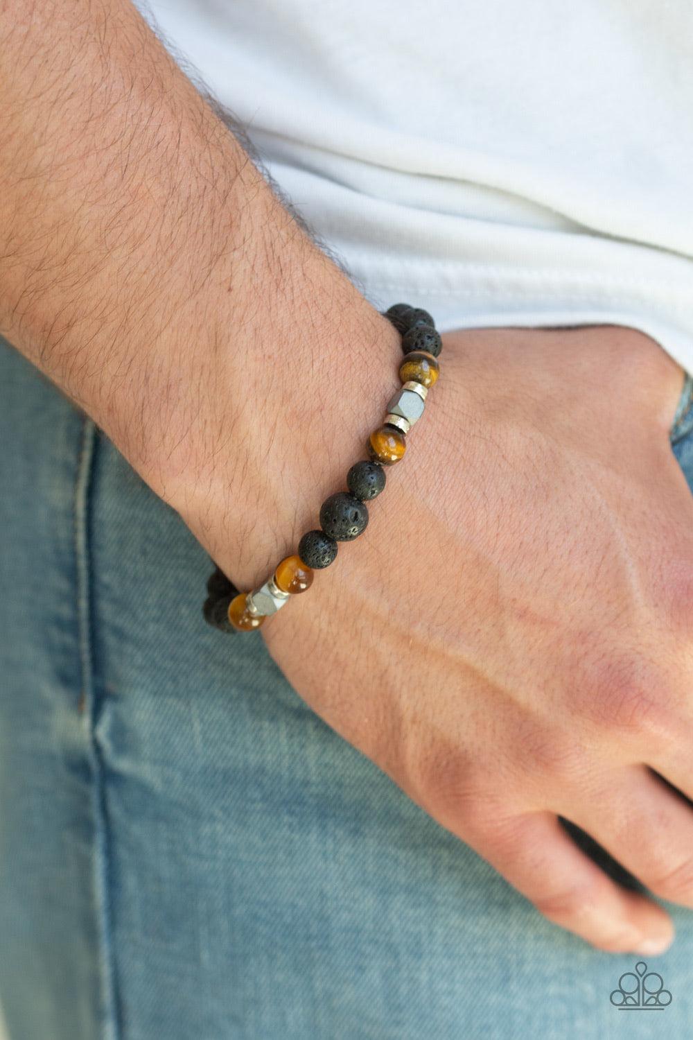 Paparazzi Accessories Strength - Brown Earthy black lava rocks, shiny tiger's eye stones, and flashy metallic accents are threaded along a stretchy band around the wrist for a seasonal flair. Jewelry