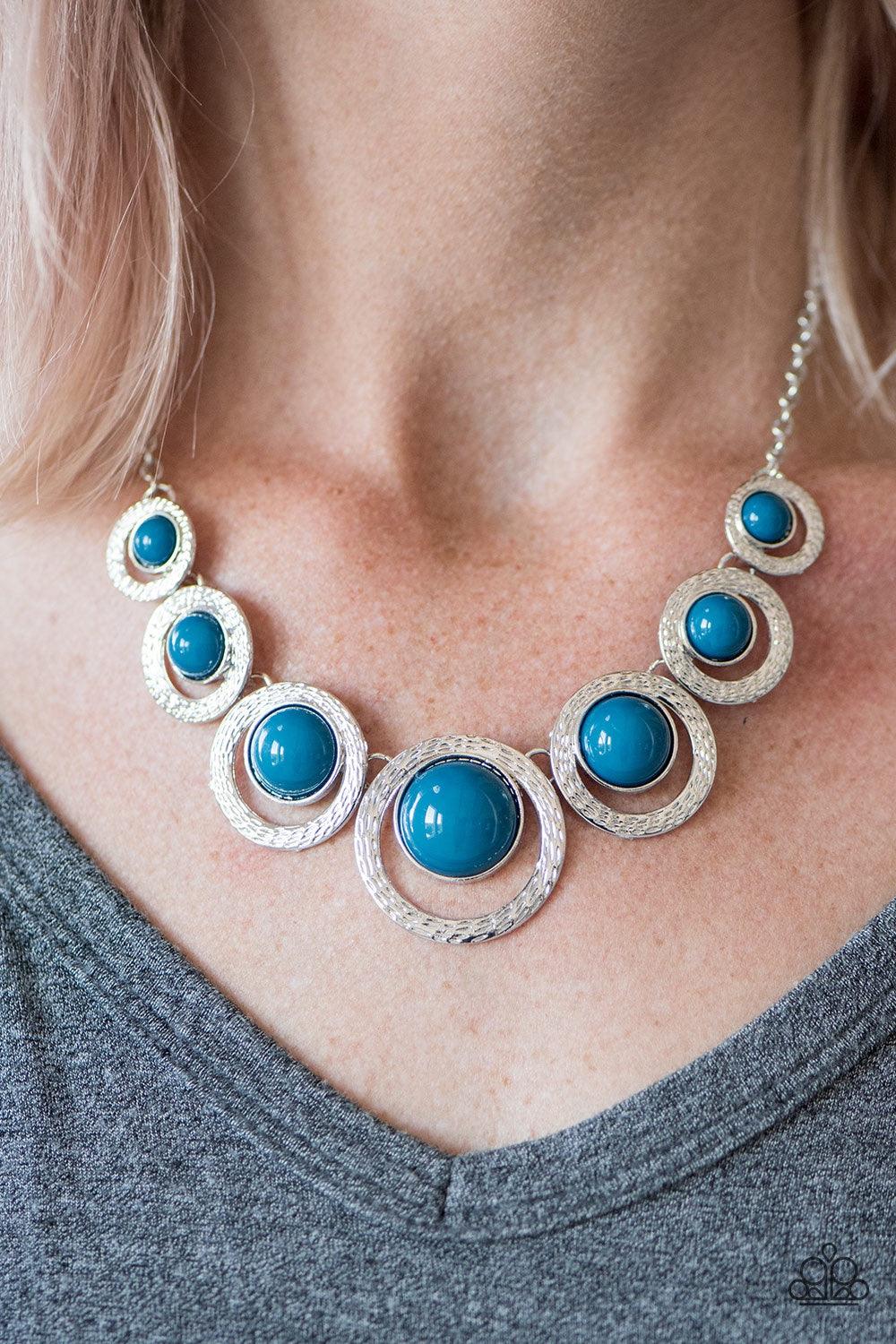 Paparazzi Accessories Jungle River - Blue Refreshing blue beads are pressed into the centers of delicately hammered silver frames, creating colorful accents below the collar. The shiny blue beads gradually increase in size as they near the center, adding