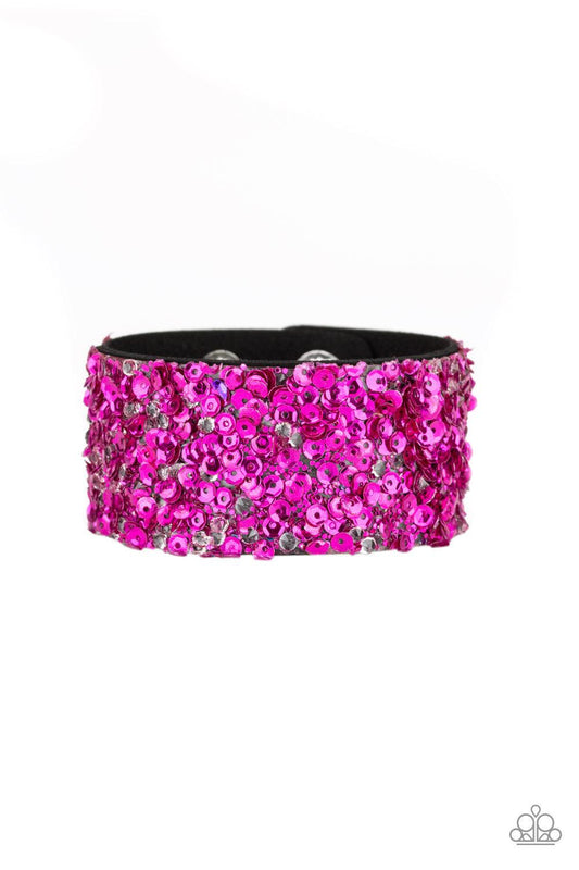 Paparazzi Accessories Starry Sequins - Pink A collision of glittery rhinestones and sparkling pink sequins are encrusted along the front of a black suede band, creating blinding shimmer around the wrist. Features an adjustable snap closure. Jewelry