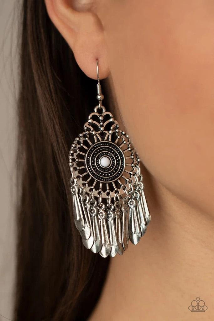 Paparazzi Accessories Dream a Little DREAMCATCHER - White Dainty silver bars flare out from a white beaded center bordered in ripples of studded detail, creating a frilly frame. Dotted with floral accents, flared silver plates swing from the bottom of a w