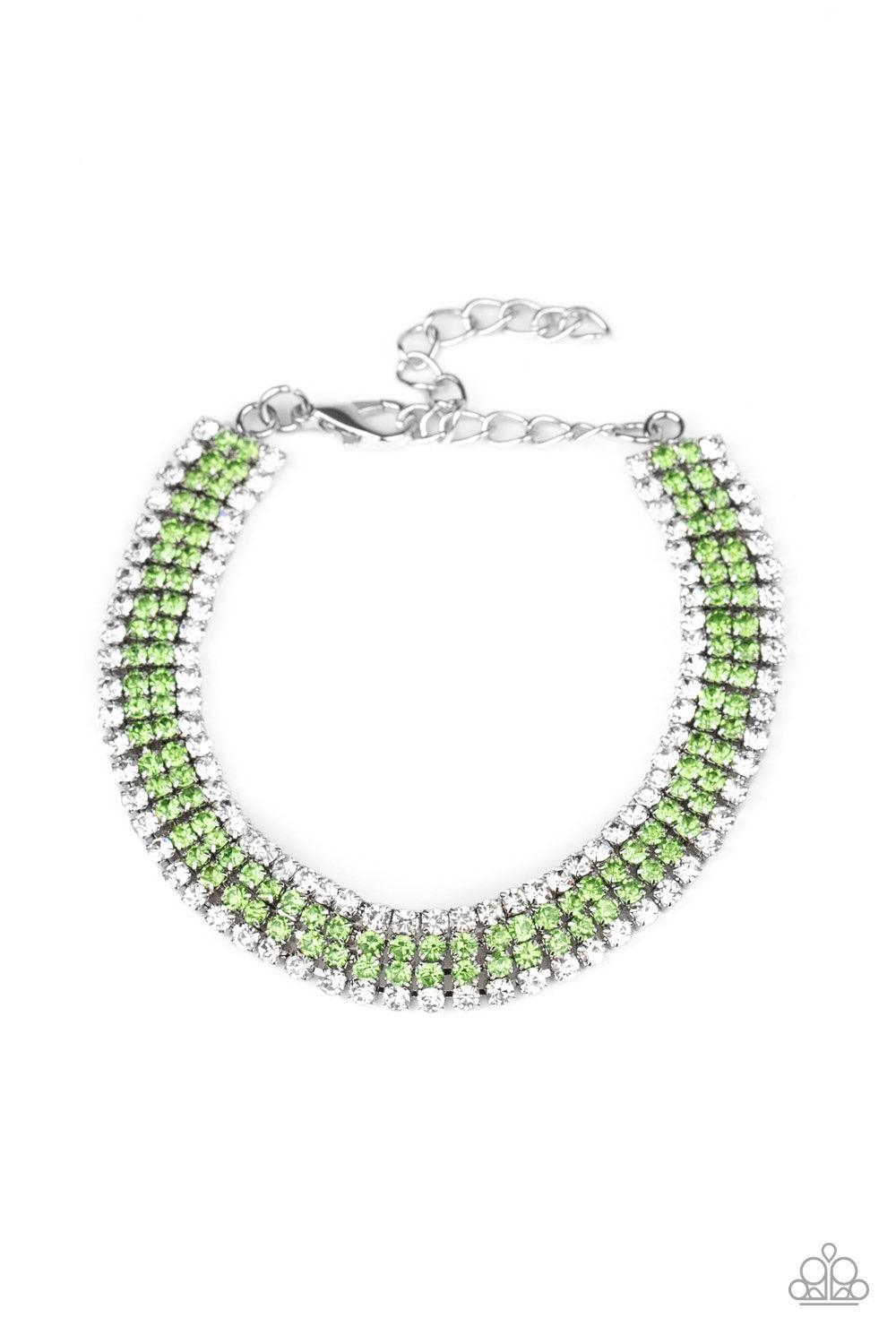 Paparazzi Accessories Color Me Couture - Green Flanked by strands of glassy white rhinestones, two rows of glittery green rhinestones layer across the wrist, coalescing into a single strand of glitz. Features an adjustable clasp closure. Jewelry