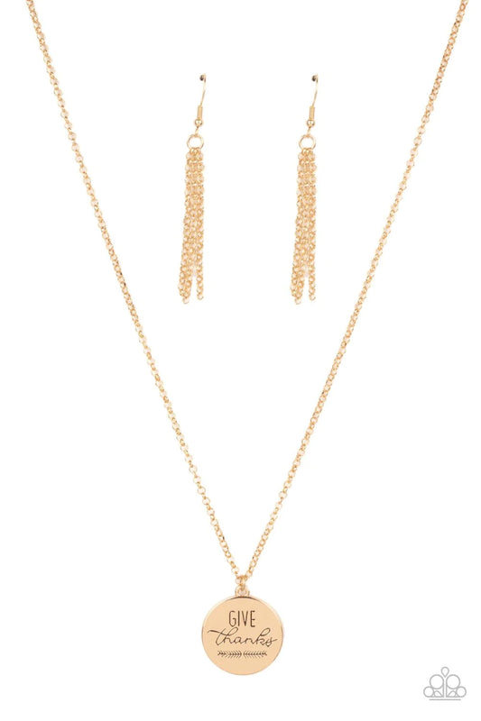Paparazzi Accessories Give Thanks - Gold Infused with feathery accents, a shiny gold disc is stamped in the phrase, "Give Thanks," at the bottom of a shimmery gold chain. Features an adjustable clasp closure. Sold as one individual necklace. Includes one