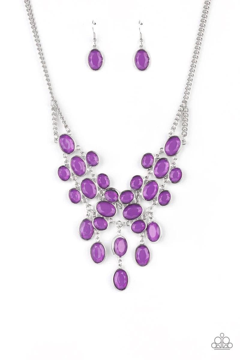 Paparazzi Accessories Serene Gleam - Purple A stunning array of oval cut Amethyst Orchid gems, pressed into silver frames, interconnect into a spectacular princess-like bib design. The display rests just below the collar for an exquisitely serene gleam. F