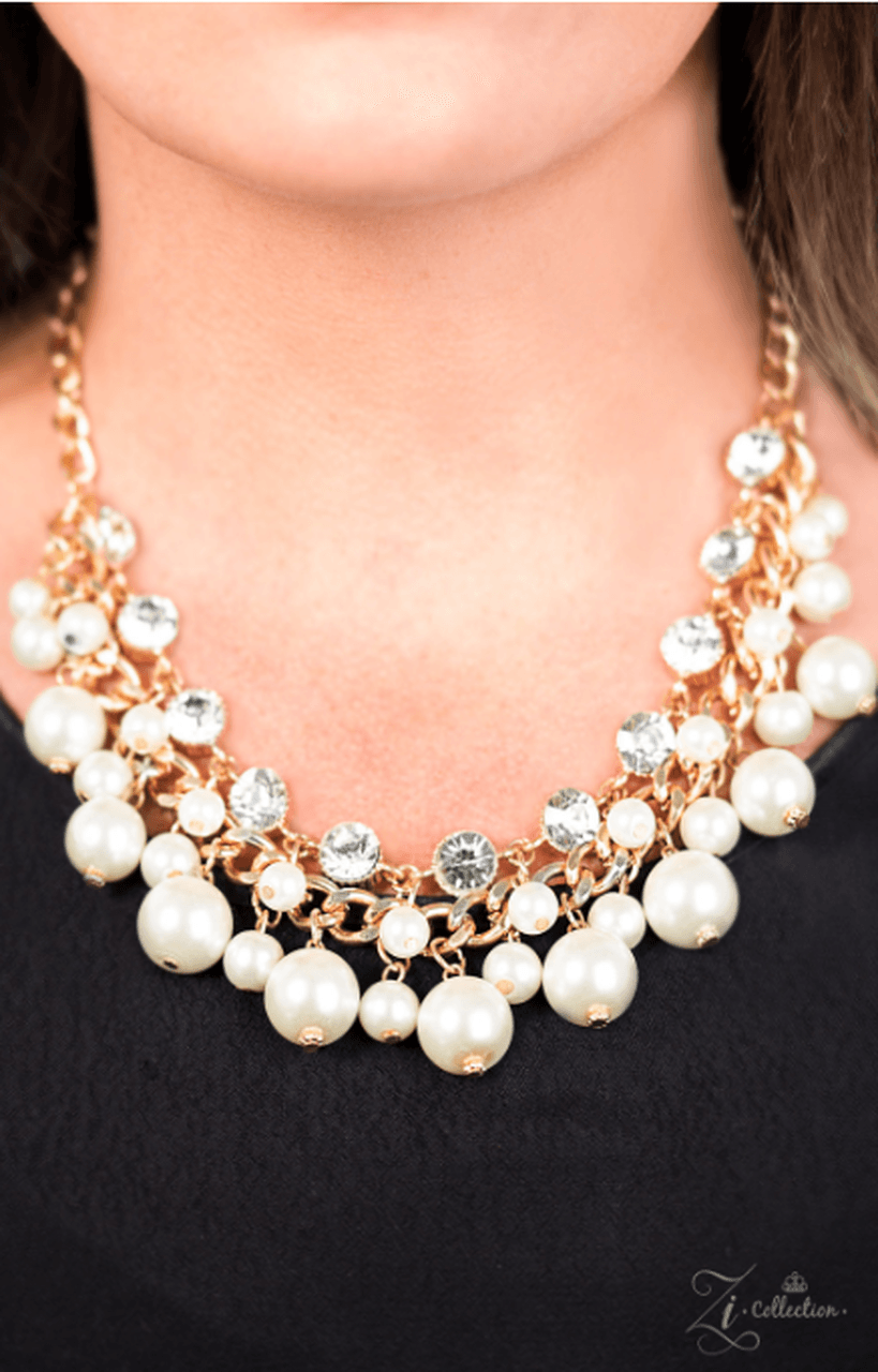 Paparazzi Accessories Idolize A row of dramatic white rhinestones gives way to a strand of chunky gold chain and row after row of pearlescent fringe. The stacked rows join together, creating flirty movement. Features an adjustable clasp closure. Jewelry