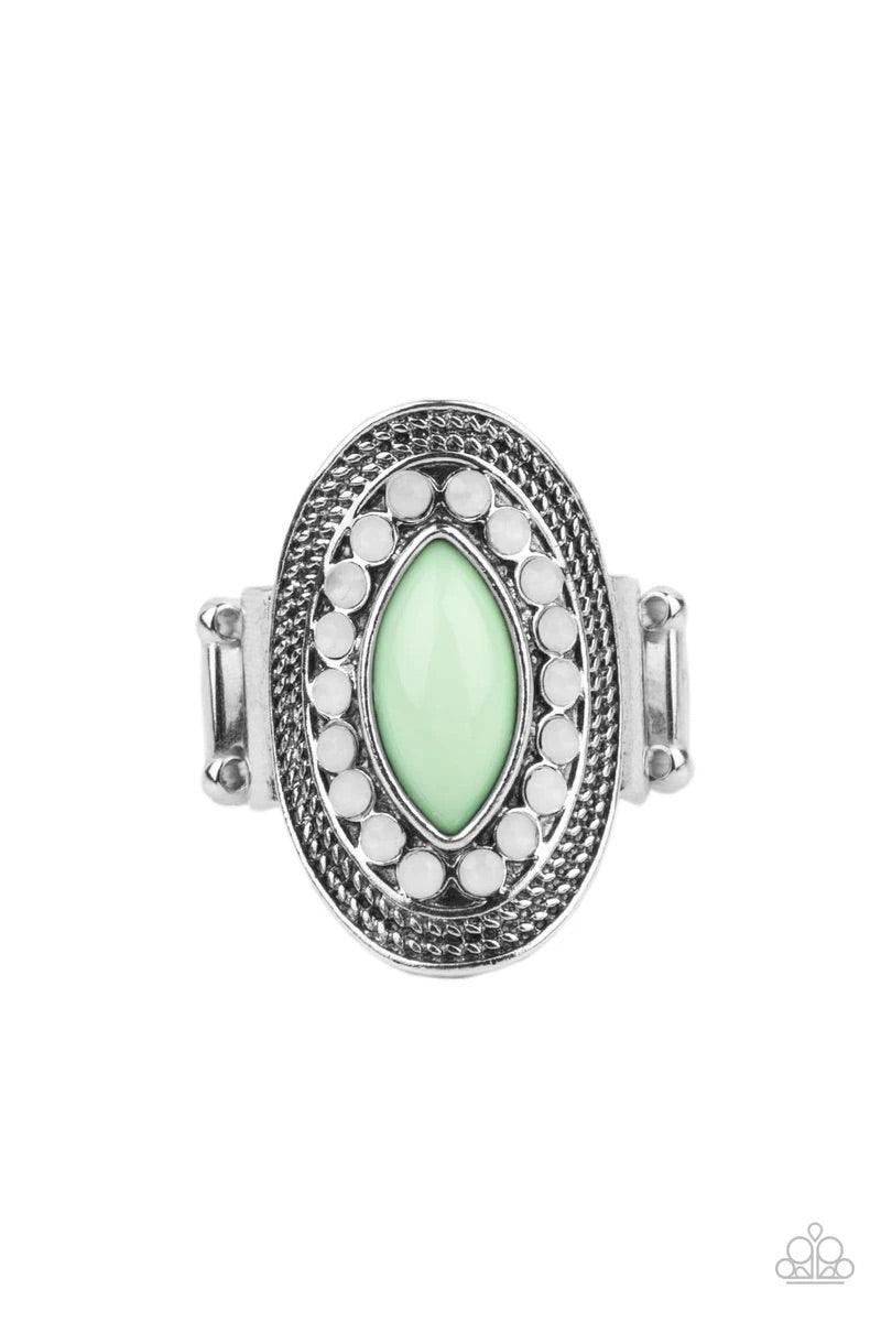 Paparazzi Accessories Tea Light Twinkle ~Green A silver frame embellished with dewy white beads and studded silver texture creates a stunning backdrop for a Green Ash marquise cut bead as it sits atop the finger. Features a stretchy band for a flexible fi
