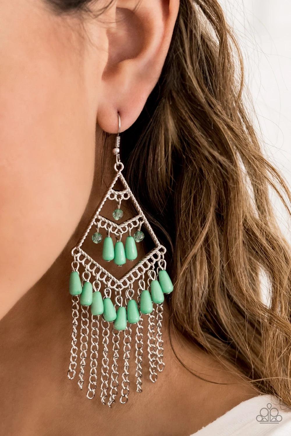 Paparazzi Accessories Trending Transcendence - Green Infused with a tapered silver chain fringe, green teardrop beads swing from the bottom of a shiny silver frame. Opaque and solid green beads swing from the top and middle of a stacked frame for a season