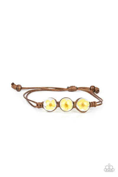 Paparazzi Accessories Prairie Persuasion - Yellow Dainty yellow blossoms are encased inside of glassy beads that are knotted in place with brown cording around the wrist, resulting a naturally beautiful centerpiece. Features an adjustable sliding knot clo