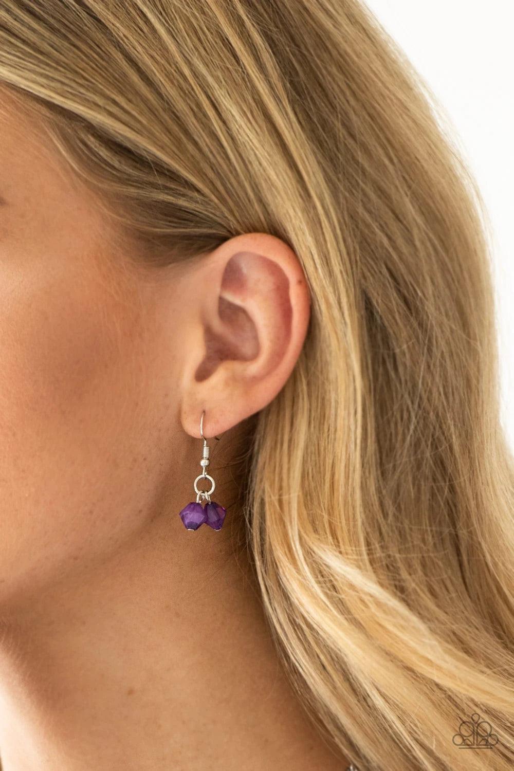 Paparazzi Accessories Grand Canyon - Purple Featuring polished and cloudy finishes, a collection of purple faux rocks dance from the bottom of a bold silver chain. Classic silver beads trickle between the colorful beading, adding a metallic shimmer to the