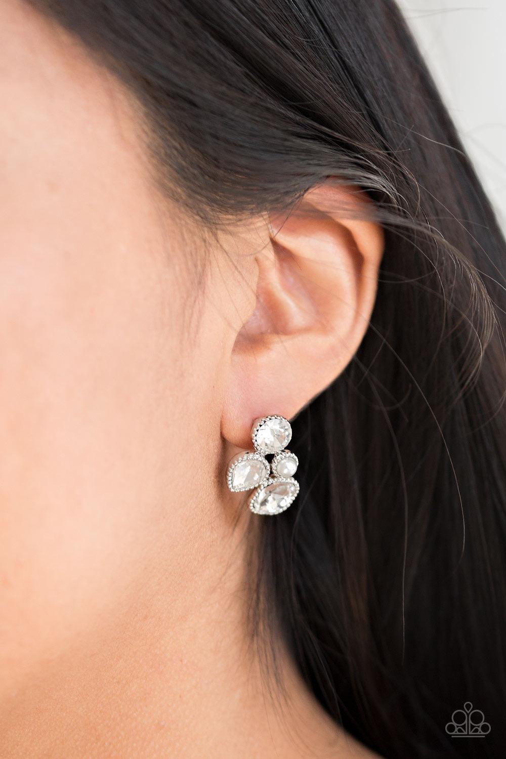Paparazzi Accessories Super Superstar - White Infused with a dainty white pearl, mismatched white rhinestones coalesce into a glittery frame. Earring attaches to a standard post fitting. Jewelry