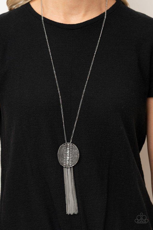 Paparazzi Accessories Radical Refinery- Silver An oversized concave silver disc, ribbed with linear texture, creates a dramatic backdrop for a vertical row of faceted silver beads. A flirty tassel of delicate silver chains sways from the bottom of the pen