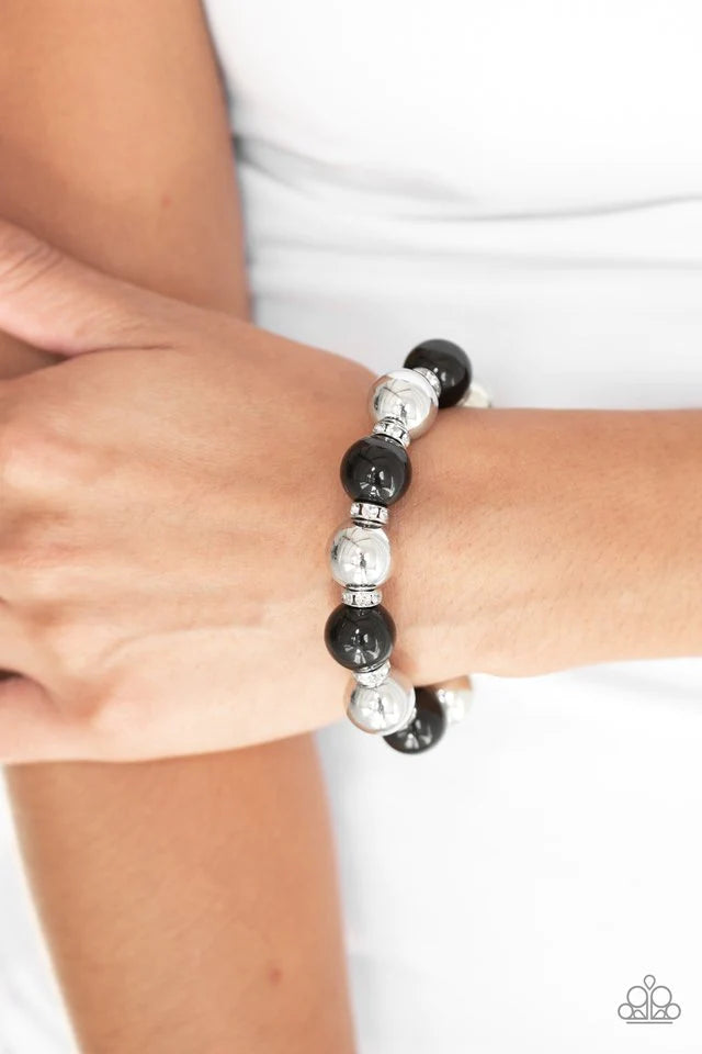 Paparazzi Accessories So Not Sorry - Black A collection of white rhinestone encrusted rings, shiny black beads, and classic silver beads are threaded along a stretchy band around the wrist for a glamorous look. Sold as one individual bracelet. Bracelets