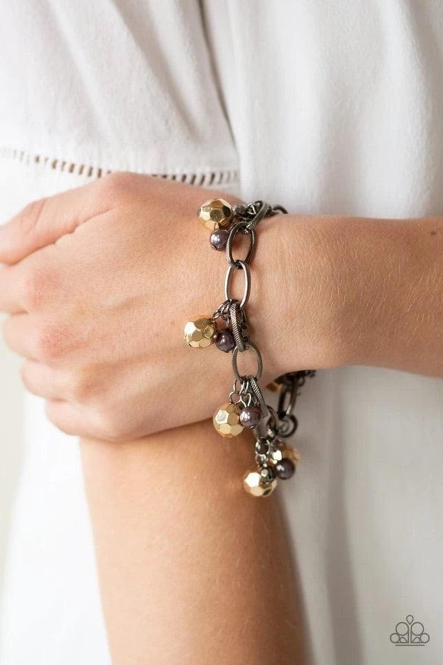 Paparazzi Accessories Make in Malibu - Multi Varying in size, a collection of faceted gold and pearly gunmetal beads swings from a bold gunmetal chain, creating a whimsical metallic fringe around the wrist. Features an adjustable clasp closure. Sold as on