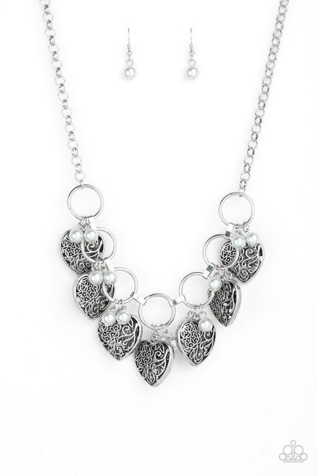 Paparazzi Accessories Very Valentine - Silver Infused with classic silver pearls, vintage locket-like heart frames swing from the bottoms of bold silver hoops, creating a flirtatious fringe below the collar. Features an adjustable clasp closure. Sold as o