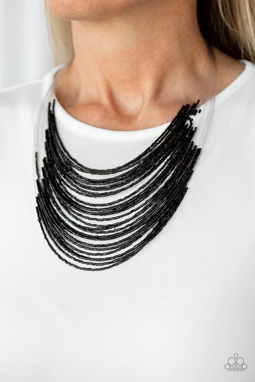 Paparazzi Accessories Catwalk Queen - Black Strand after strand of shimmering black seed beads fall together to create a bold statement piece. Features an adjustable clasp closure. Sold as one individual necklace. Includes one pair of matching earrings. J