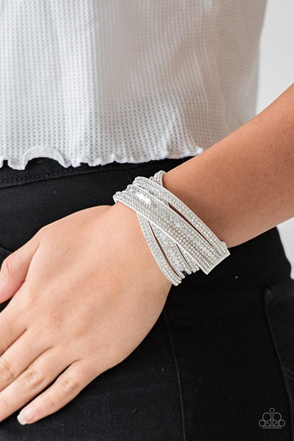 Paparazzi Accessories Rock Star Attitude - White Encrusted in rows of glassy white rhinestones and flat silver studs, three strands of gray suede wrap around the wrist for a sassy look. The elongated band allows for a trendy double wrap around the wrist.