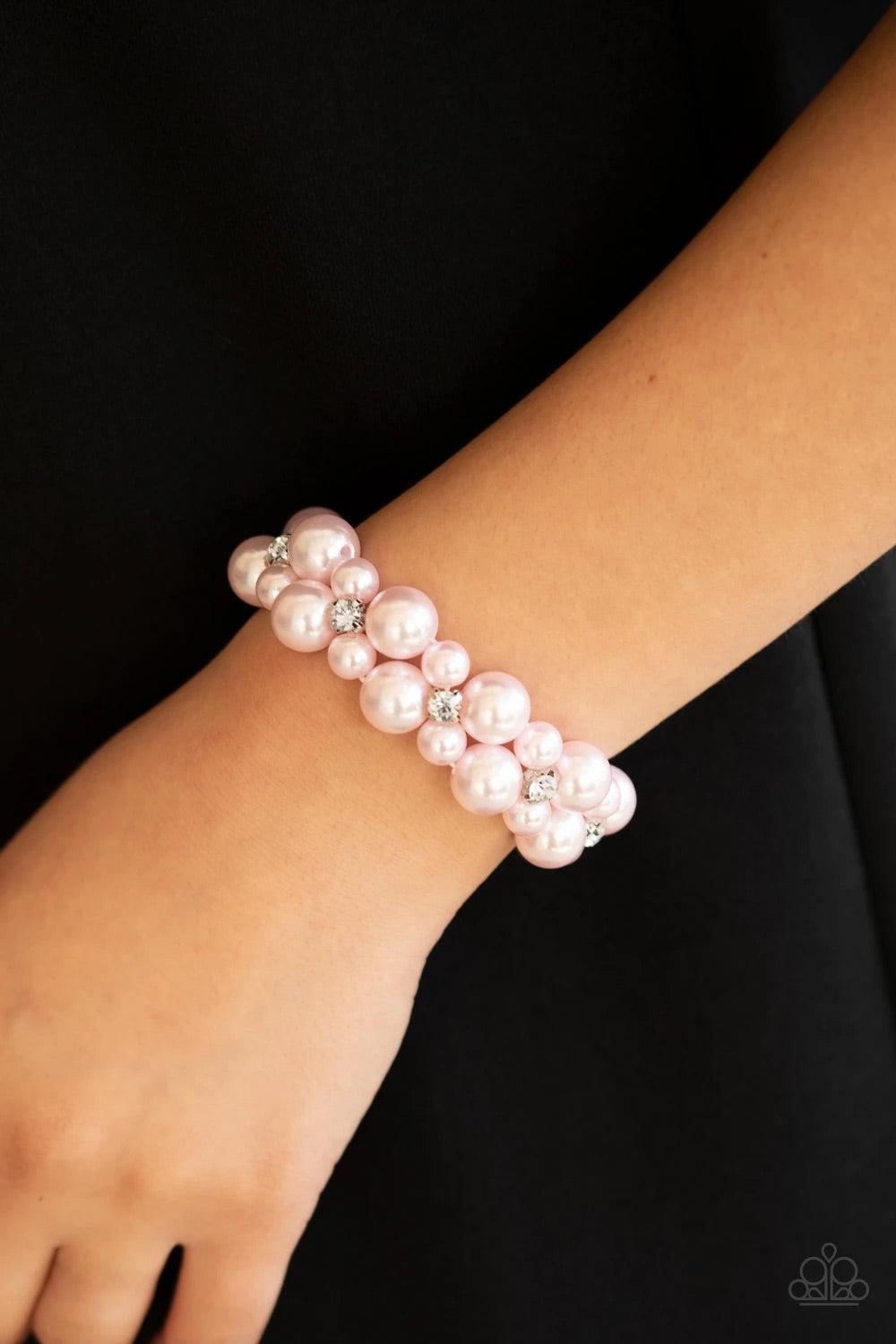 Paparazzi Accessories Flirt Alert - Pink A bubbly collection of pink pearls and classic white rhinestones are threaded along stretchy bands around the wrist, creating flirtatious refinement. Jewelry