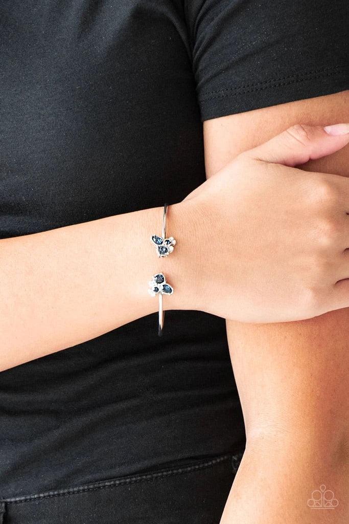 Paparazzi Accessories Going for Glitter - Blue Varying in shape, glittery blue and white rhinestones join at both ends of a dainty silver cuff, creating refined fittings. Sold as one individual bracelet. Jewelry
