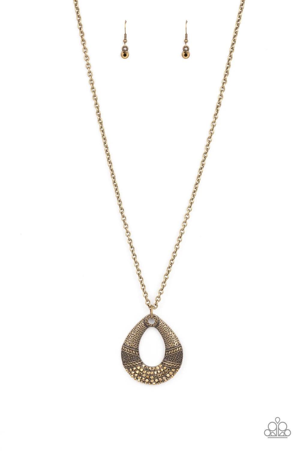 Paparazzi Accessories Glitz and Grind - Brass Studded and embossed in bands of texture, the bottom of a hammered brass teardrop is encrusted in golden topaz rhinestones, creating a glitzy pendant at the bottom of a lengthened brass chain. Features an adju