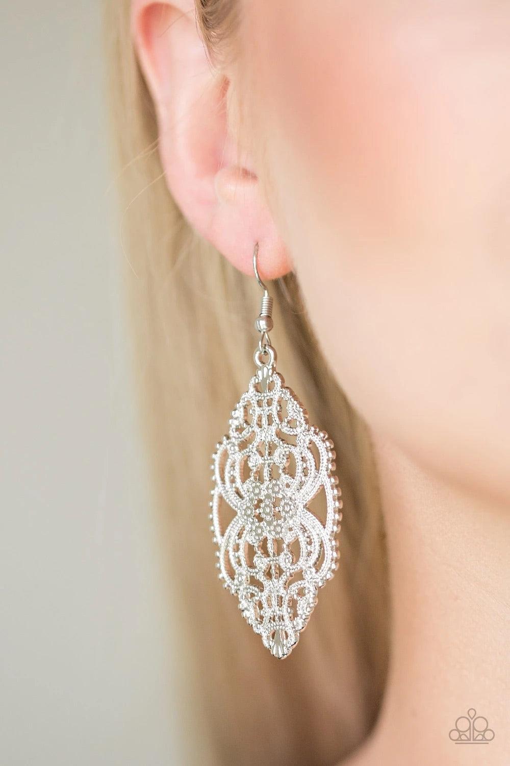 Paparazzi Accessories Ornately Ornate - Silver Brushed in a high-sheen shimmer, dotted silver filigree swoops and swirls into a regal frame. Earring attaches to a standard fishhook fitting. Sold as one pair of earrings. Jewelry