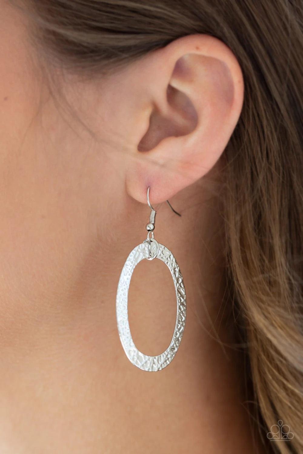 Paparazzi Accessories Glimmer Goals - Silver Delicately hammered in shimmery textures, two rows of glistening silver hoops layer down the chest for a sleek look. Features an adjustable clasp closure. Sold as one individual necklace. Includes one pair of m