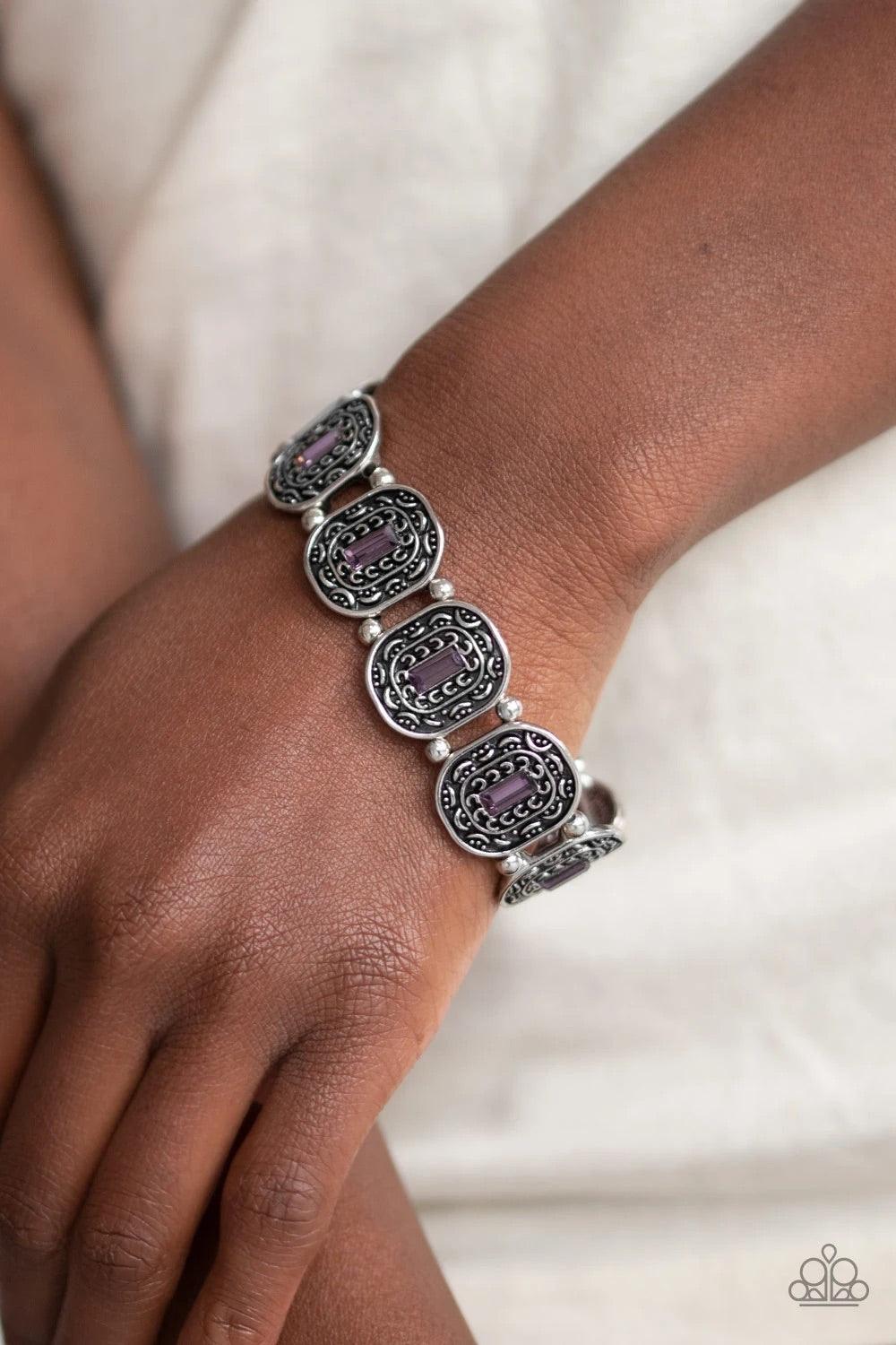 Paparazzi Accessories Hidden Fortune - Purple Featuring purple emerald-cut rhinestone centers, ornate silver frames are threaded along stretchy bands around the wrist for a refined fashion. Jewelry