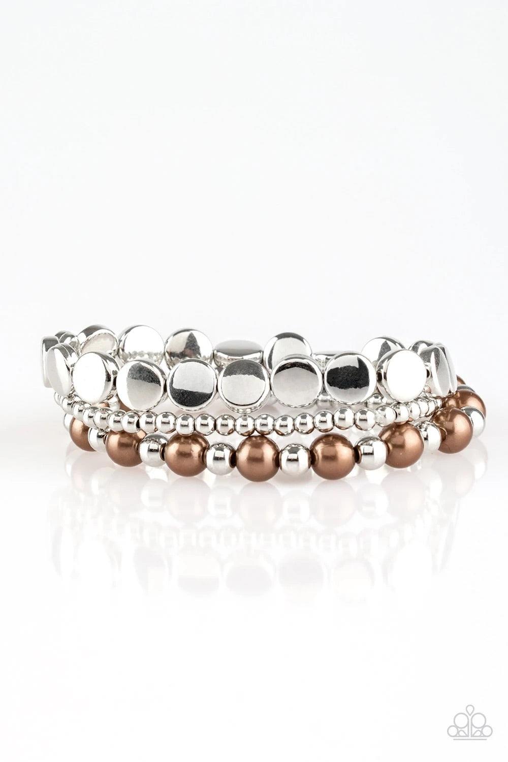 Paparazzi Accessories Girly Girl Glamour - Brown Mismatched silver and pearly brown beads are threaded along stretchy elastic bands, creating colorful layers across the wrist. Sold as one set of three bracelets. Jewelry