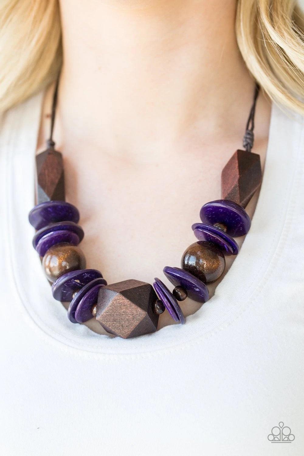 Paparazzi Accessories Pacific Paradise - Purple Featuring abstract geometric finishes, mismatched brown wooden beads and vivacious purple accents are threaded along shiny brown cording. A dramatic geometric bead adorns the center, creating a bold summery