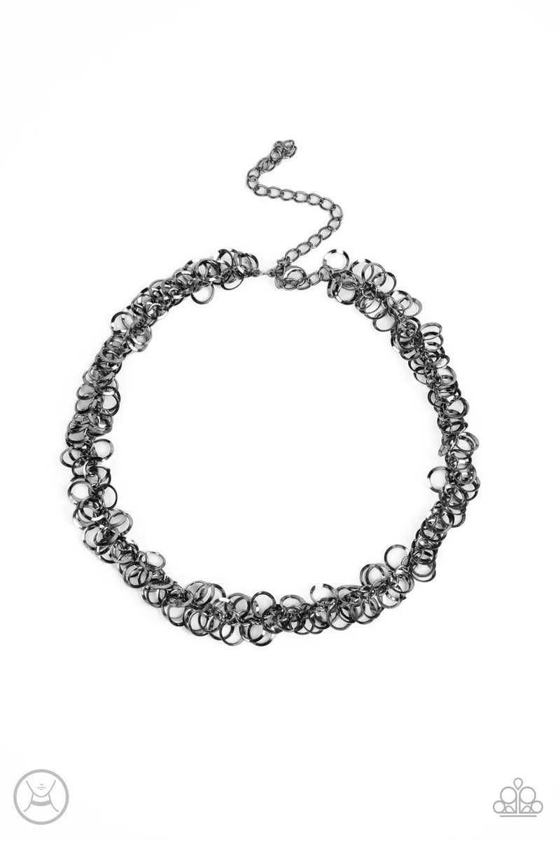 Paparazzi Accessories Cause A Commotion - Black A shiny series of flat and beveled gunmetal hoops delicately cluster along a dainty gunmetal chain around the neck, creating a tinkling fringe. Features an adjustable clasp closure. Sold as one individual ch