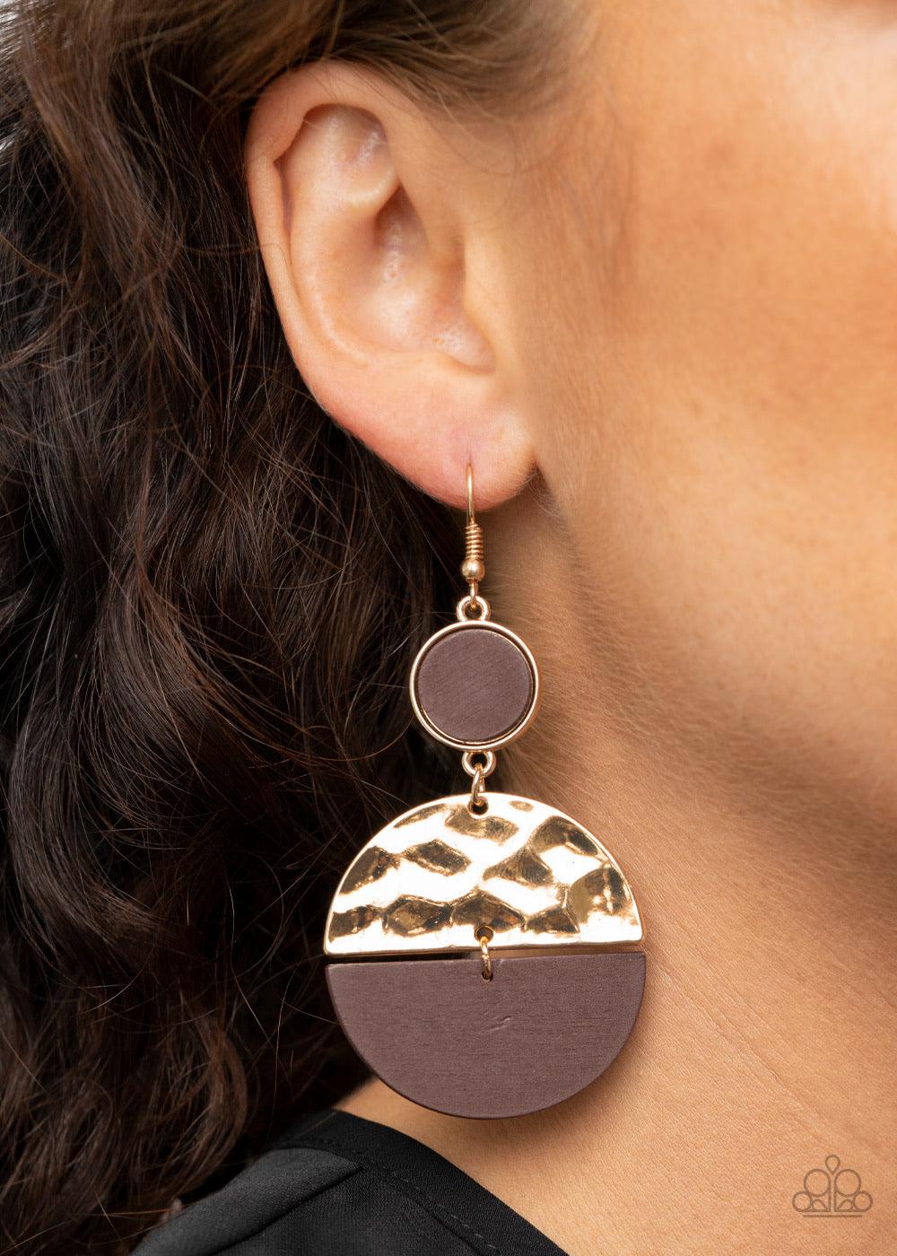 Paparazzi Accessories Natural Element - Gold A brown wooden crescent and hammered gold crescent link at the bottom of a round gold frame dotted with a brown wooden center for an earthy flair. Earring attaches to a standard fishhook fitting. Sold as one pa