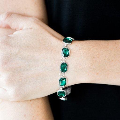 Paparazzi Accessories Deluxe Sparkle - Green Featuring regal emerald style cuts, glittery green gems link across the wrist in an undeniably sparkly fashion. Features an adjustable clasp closure. Jewelry