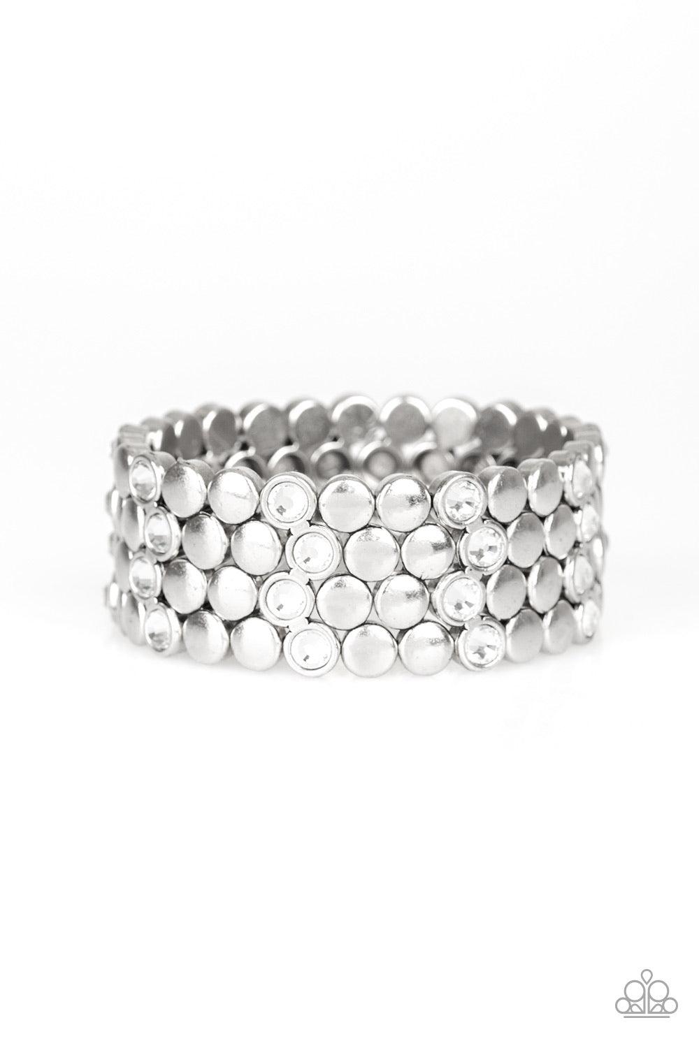 Paparazzi Accessories Scattered Starlight - White A collection of frames featuring flat silver studs and glittery white rhinestones are threaded along a stretchy band, scattering sparkle across the wrist. Jewelry