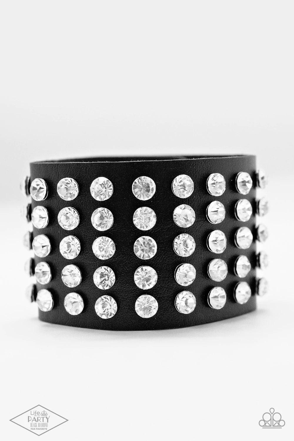 Paparazzi Accessories Mama Said Knock You Out - Black A chunky band of black leather is embellished with rows and rows of sparkling white rhinestones. With some urban edge and undeniable shimmer, the unified sparkle creates a bold centerpiece. Features an