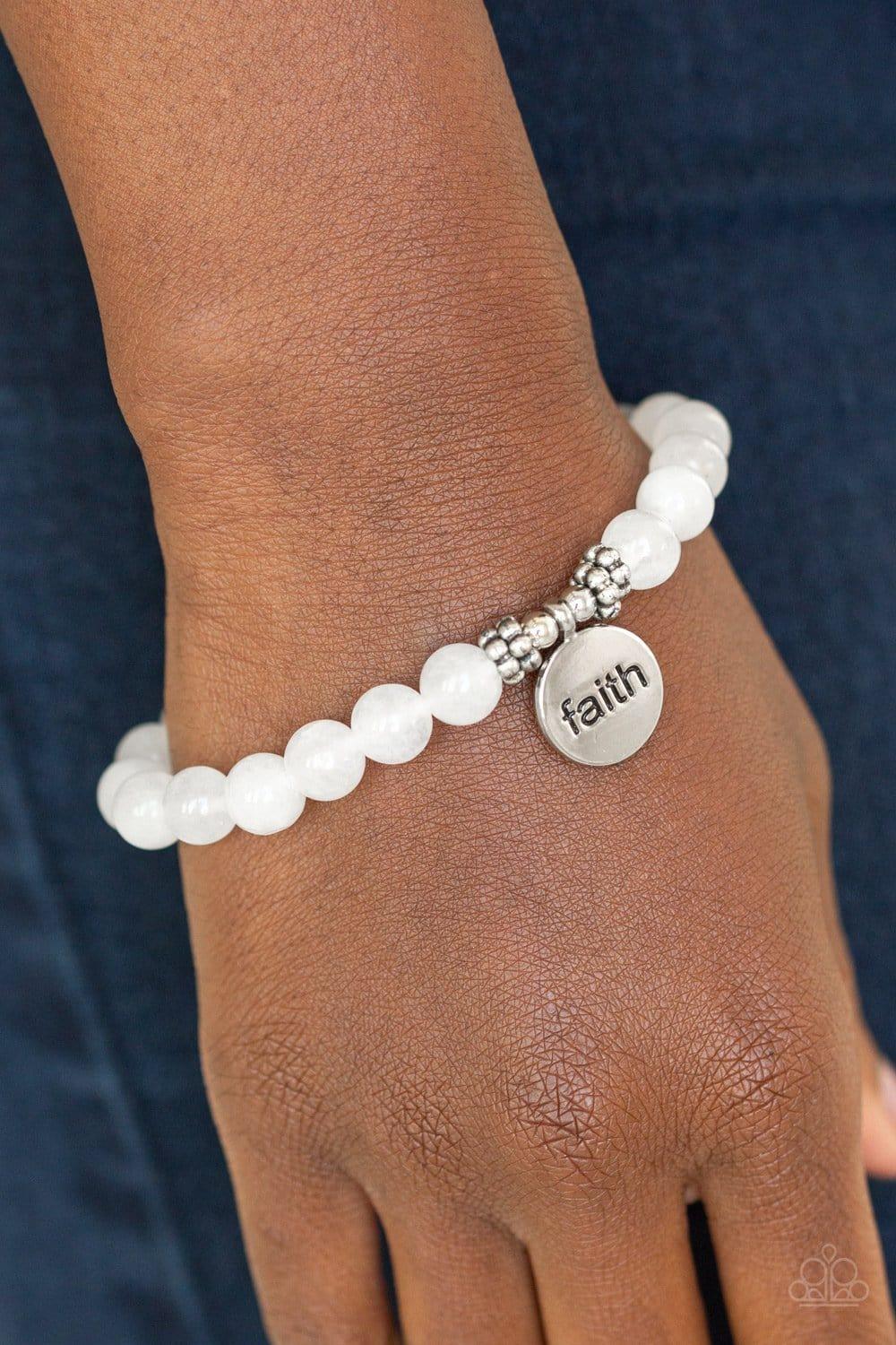 Paparazzi Accessories FAITH It, Till You Make It - White A refreshing collection of glassy stone beads are threaded along a stretchy band around the wrist for a seasonal flair. A shimmery silver disc stamped in the word, "faith", swings from the wrist for